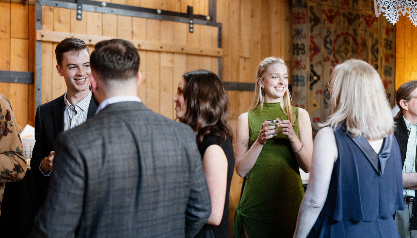 Group of people mingling and drinking wine at a McPherson Cellars event